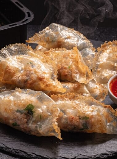 Can you cook rice paper dumplings in an air fryer? recipe hero presentation - Stunning photorealistic hero shot of crispy golden rice paper dumplings cooked in an air fryer, serv