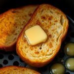 Can you toast frozen garlic bread in the air fryer? recipe hero presentation - A close-up shot of golden-brown frozen garlic bread slices being toasted inside a modern air fryer b