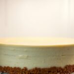 How long does it take for a runny cheesecake to set in the fridge? recipe hero presentation - A photorealistic close-up of a creamy New York style cheesecake chilling inside a clean refrigerator