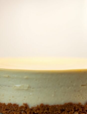 How long does it take for a runny cheesecake to set in the fridge? recipe hero presentation - A photorealistic close-up of a creamy New York style cheesecake chilling inside a clean refrigerator